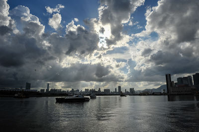 Scenic view of river by buildings against sky