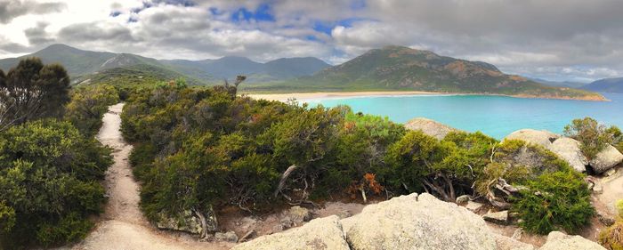 Panoramic view of sea and mountains against sky
