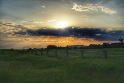 Scenic view of field against sky during sunset