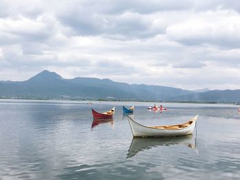 Boat moored in sea against sky