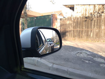 Reflection of road in side-view mirror of car