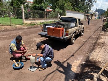 High angle view of people sitting on street