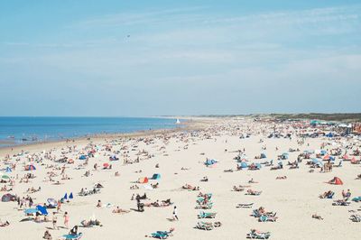 High angle view of people at beach against sky