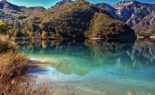 Scenic view of lake and mountains against sky