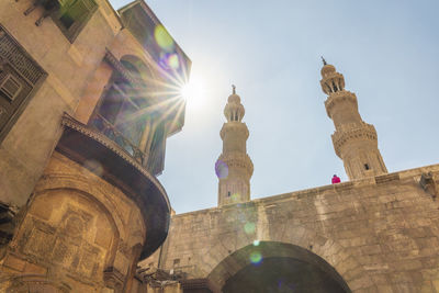 Egypt, cairo, sun shining over bab zuweila gate
