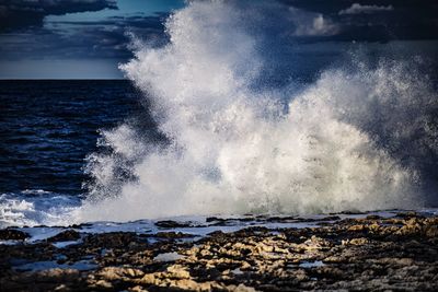 Waves splashing on rocks at shore