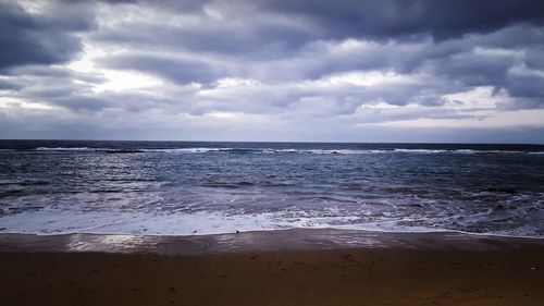 Scenic view of sea against cloudy sky