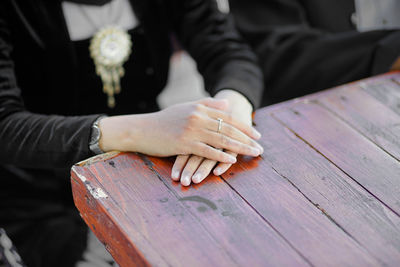 Close-up of couple hands on table