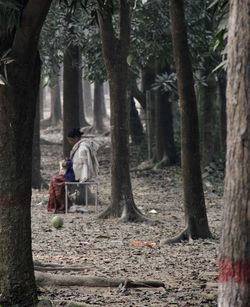 Woman sitting alone lonely under the tree.