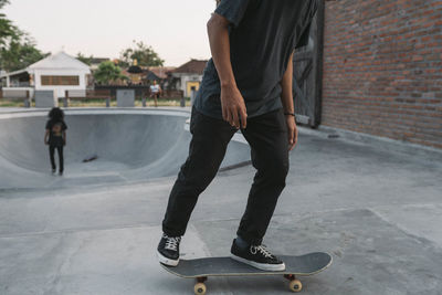 Low section of man skateboarding on skateboard