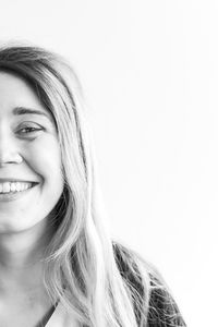 Portrait of a smiling young woman over white background