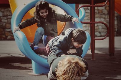 Cute girl playing on slide at playground