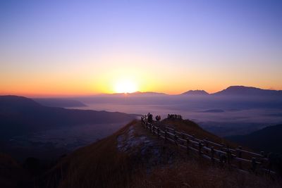 Silhouette of people on mountain during sunset