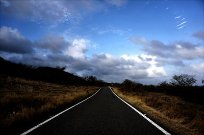 Empty road passing through landscape