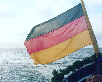 Low angle view of flag against sky