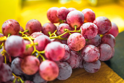 Close-up of red grapes on cutting board