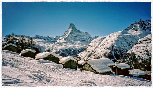 Scenic view of mountains against blue sky