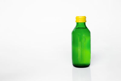 Close-up of green bottle against white background