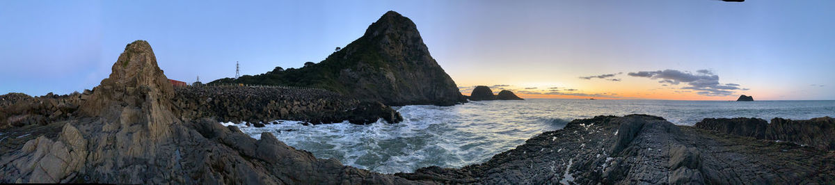 Panoramic view of rocks on beach against sky