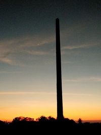 Low angle view of silhouette trees against sky at sunset