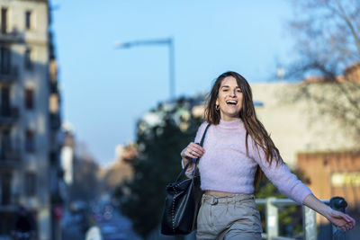 Portrait of smiling woman walking in city