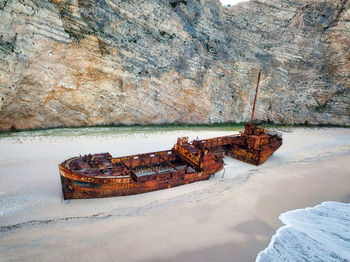 Abandoned boat on sea shore