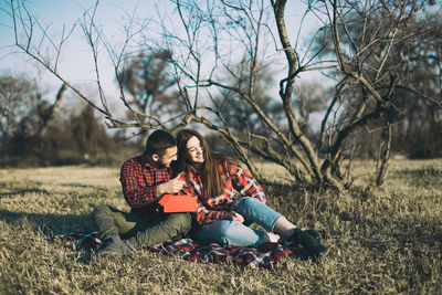 Young couple sitting on land