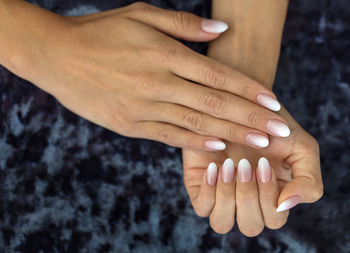Close-up of woman hands with nail polish on fingernails