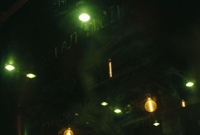 Low angle view of lit lights at night