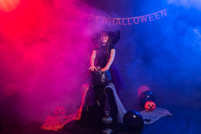 Woman holding illuminated lighting equipment