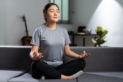 Portrait of young woman exercising at gym