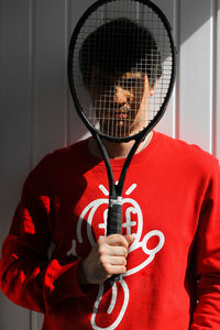 Full length portrait of person holding red umbrella