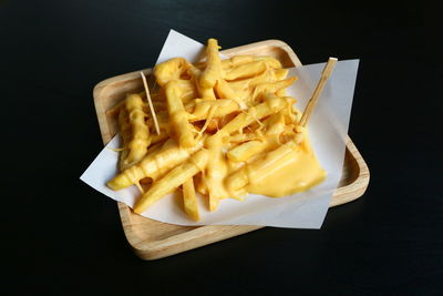 High angle view of pasta served on plate against black background