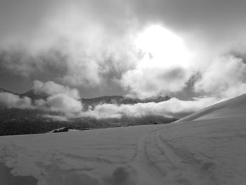 Scenic view of snow covered landscape against sky