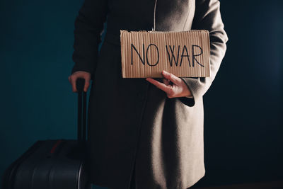 Midsection of woman holding banner