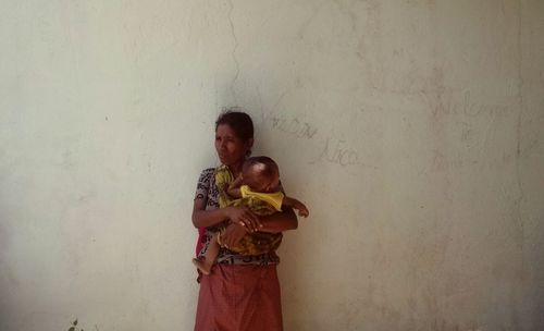 Portrait of young woman holding hands