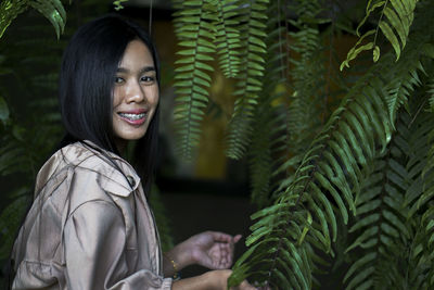 Portrait of smiling young woman standing outdoors