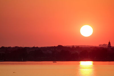 Scenic view of sea against orange sky