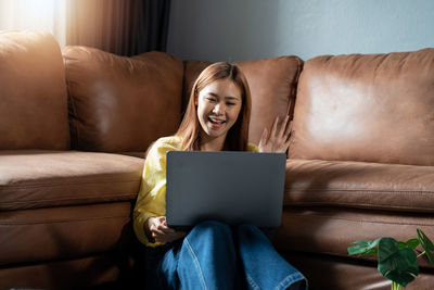 Young woman using laptop at home