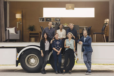 Full length portrait of confident multi-ethnic business team at portable office truck