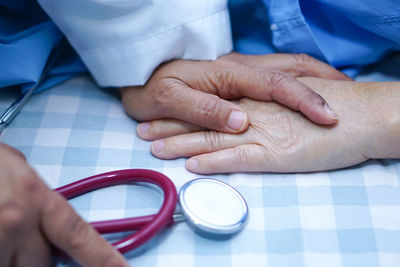 Midsection of man holding hands