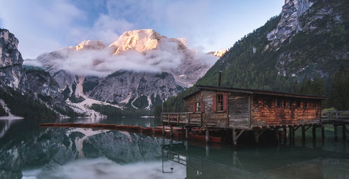 House over lake against mountains