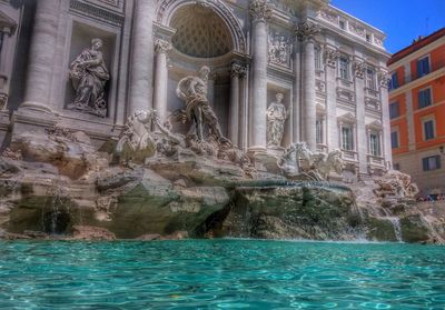 Statue of building with water in background