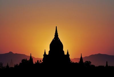 Silhouette temple against sky during sunset