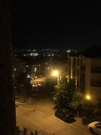 High angle view of illuminated street and buildings at night