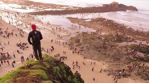 Rear view of people walking on land