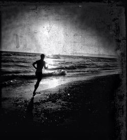 Full length of woman standing on beach