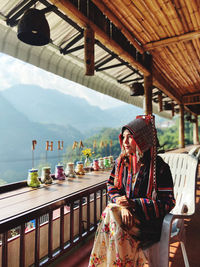 Portrait of smiling woman sitting on chair at observation point