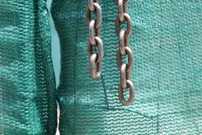 Close-up of metal chain by lobster traps