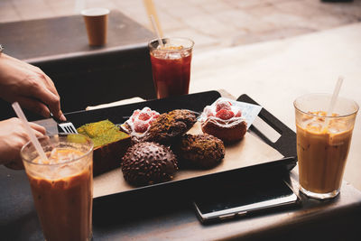 Cropped hands of person having food in restaurant